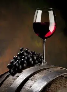 glass of red wine on a barrel